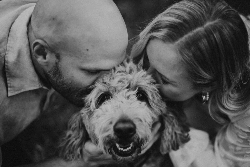 couple embracing dog during engagement session